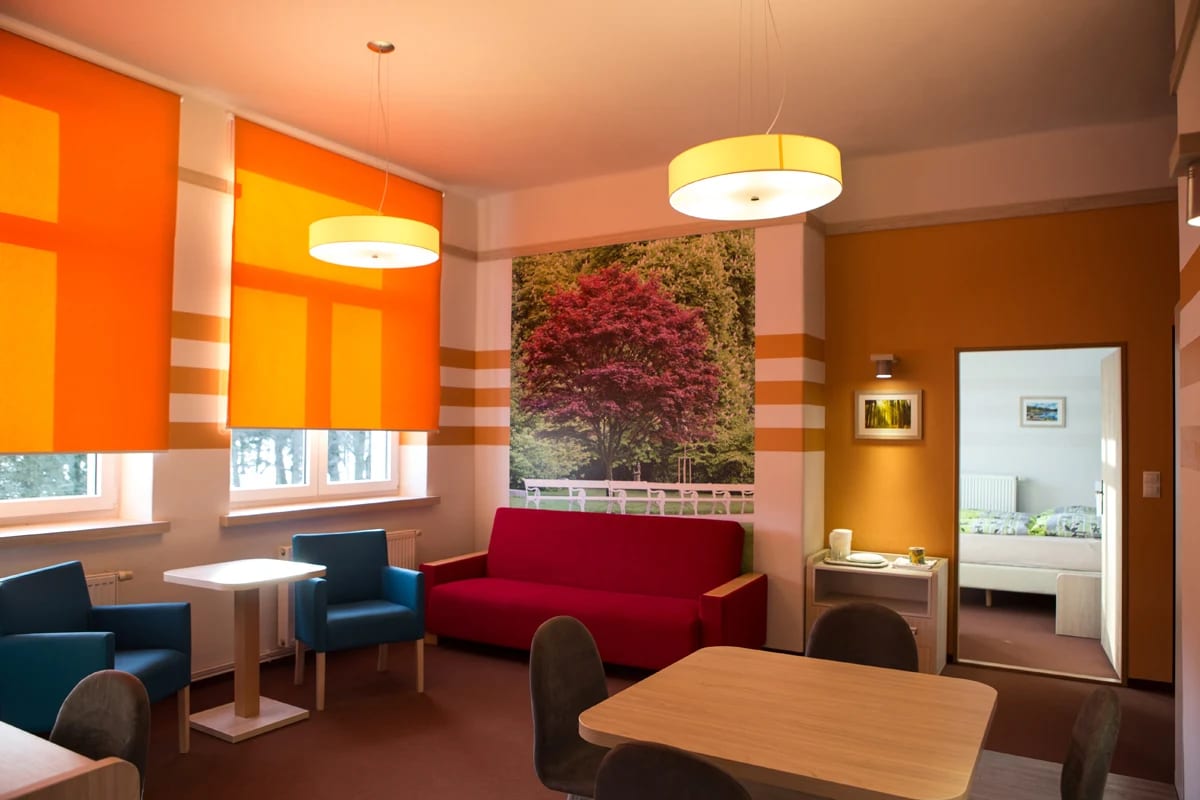 Renovated room with a seating area and adjoining bedroom
